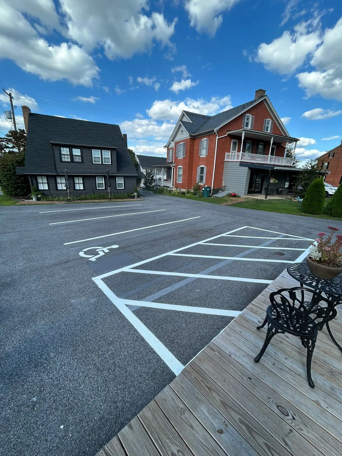 White hatched ADA access aisle and symbol on a small commercial lot