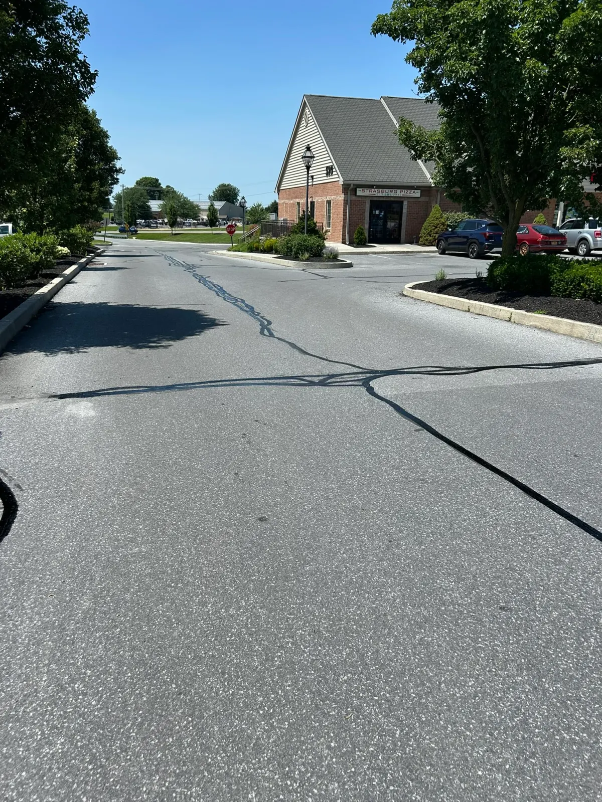 Sealed cracks running along a commercial entrance drive