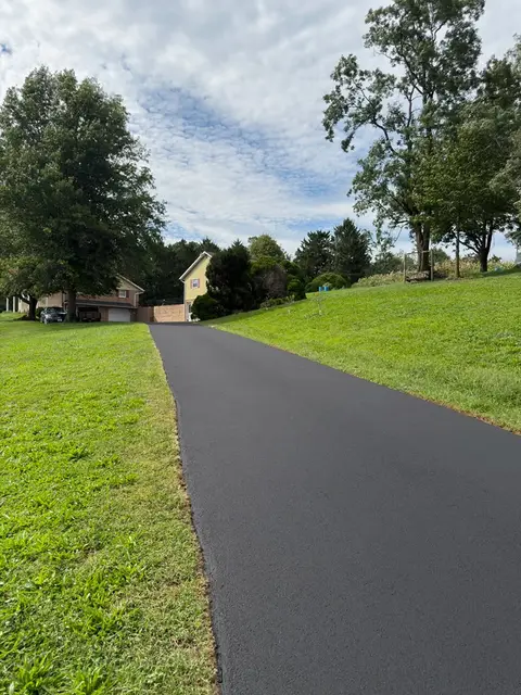 Long straight driveway sealcoated up to the house