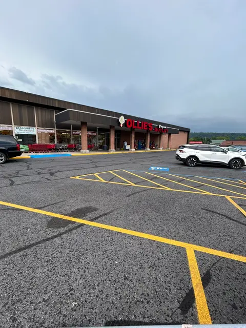 Restriped retail parking lot with yellow lines and a blue ADA stall