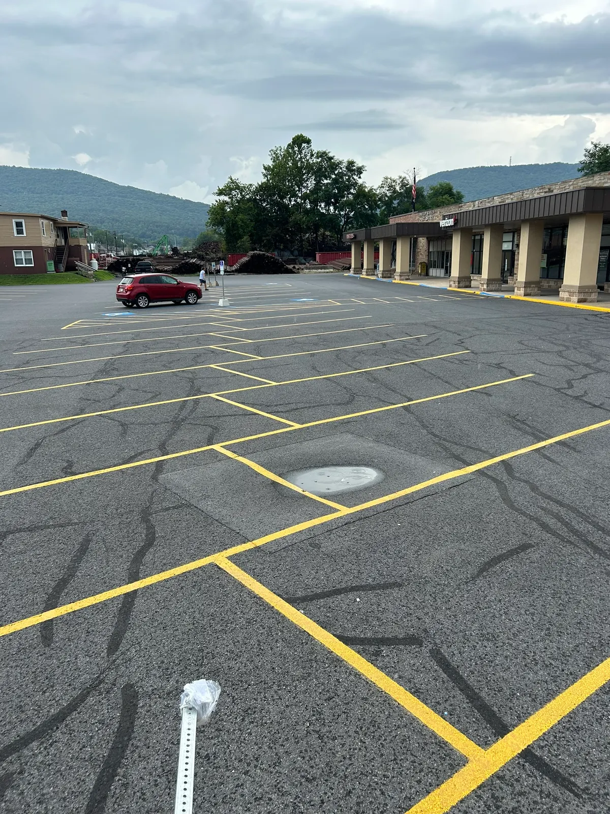 Yellow hatched striping and parking lines in a shopping center lot