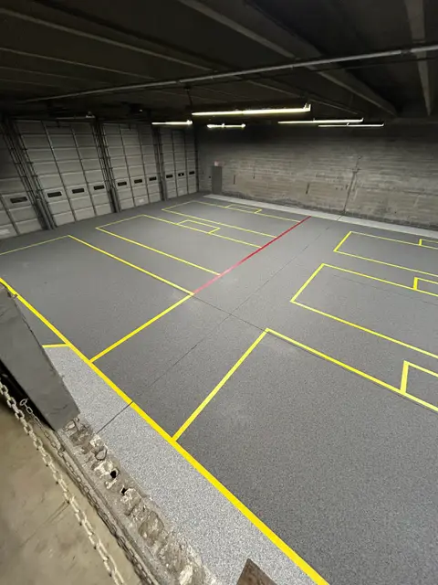 Marked work zones on an industrial floor in front of dock doors